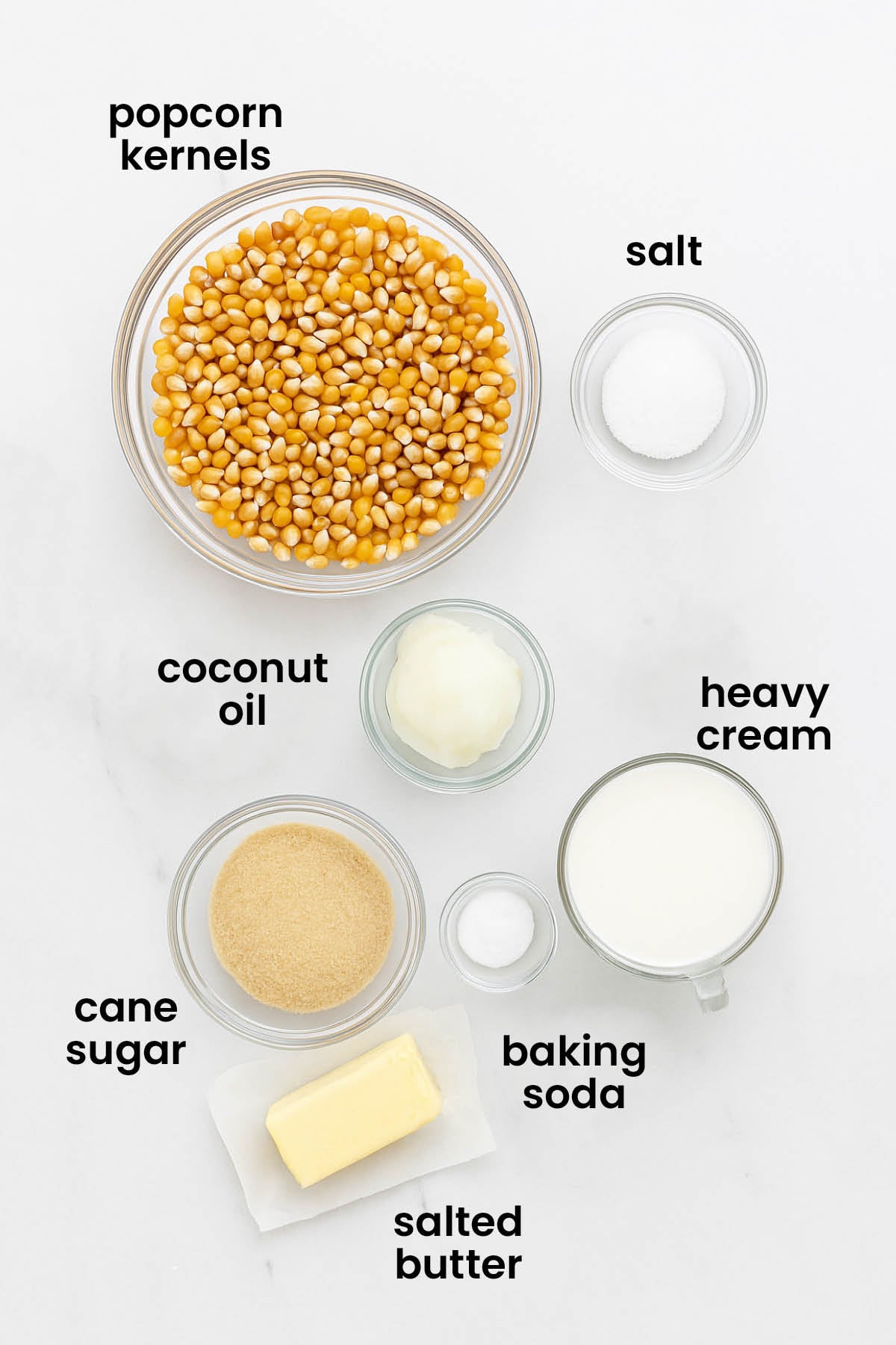 individual ingredients for organic caramel corn without corn syrup laid out against a white background.