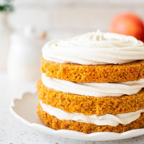 3 layer honey apple carrot cake on a ruffle cake plate.