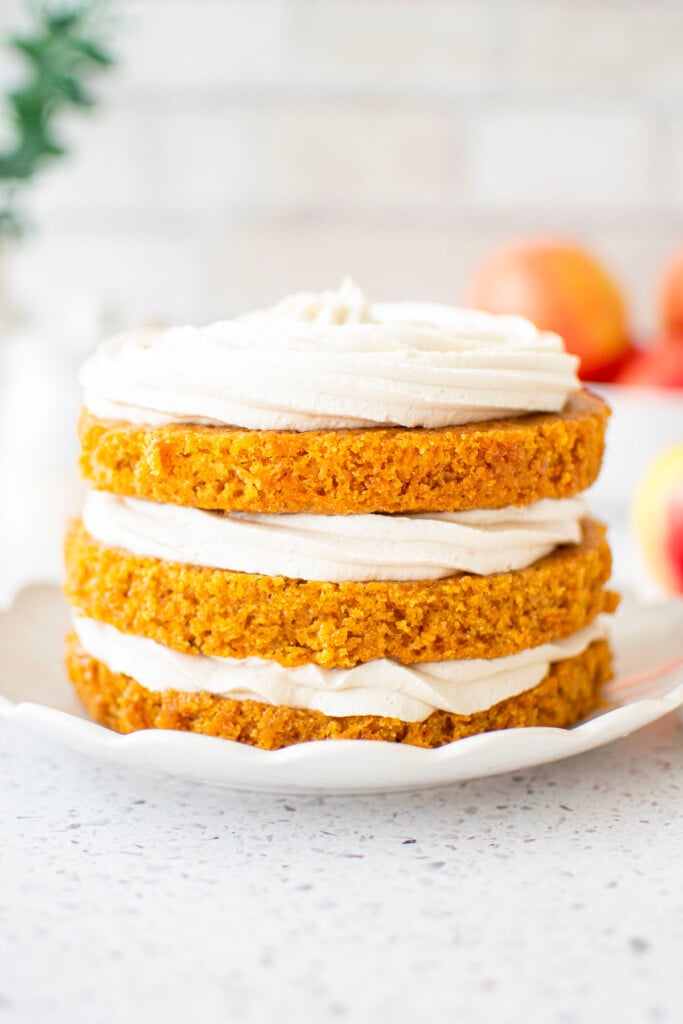 3 layer honey apple carrot cake on a ruffle cake plate.