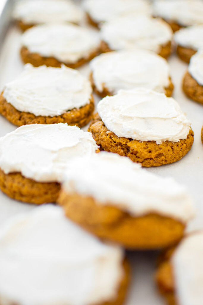 baking sheet of frosted pecan pumpkin spice cookies.