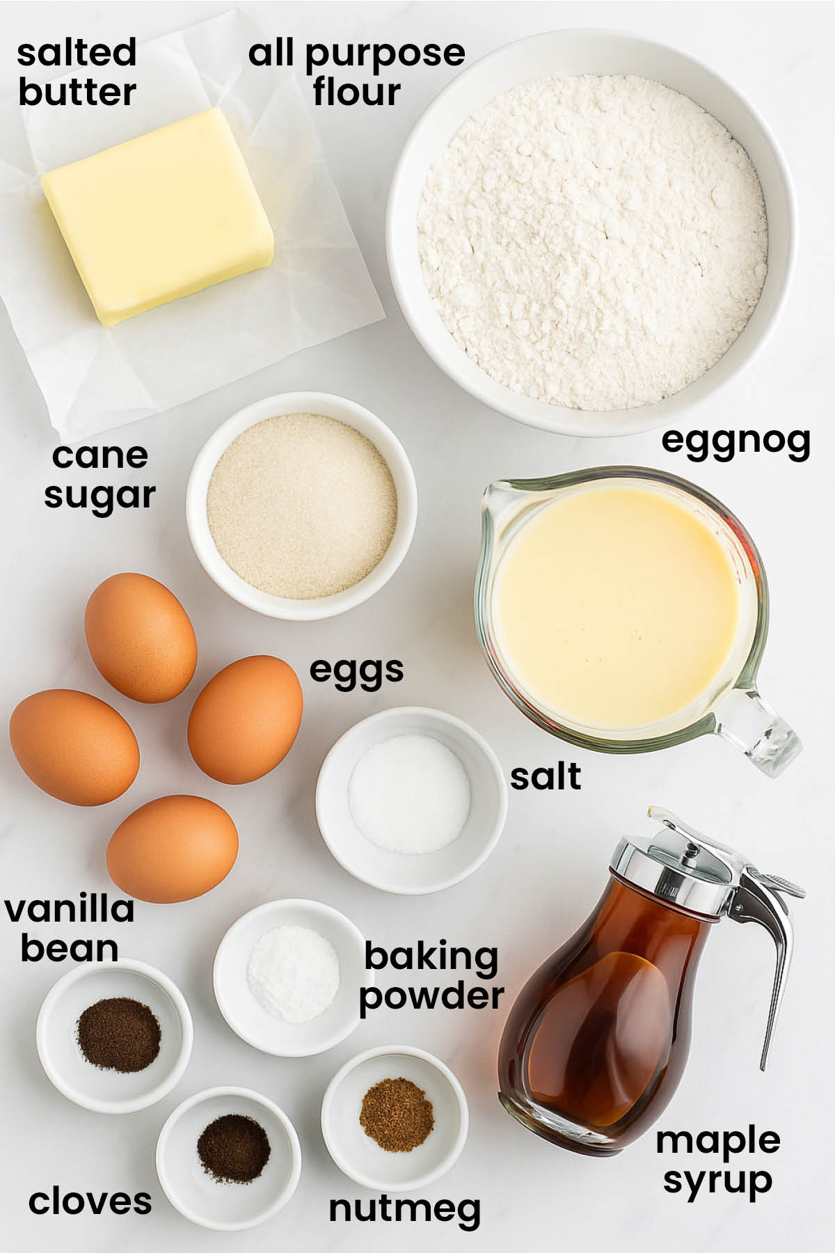 individual ingredients for eggnog waffles laid out against a white background.