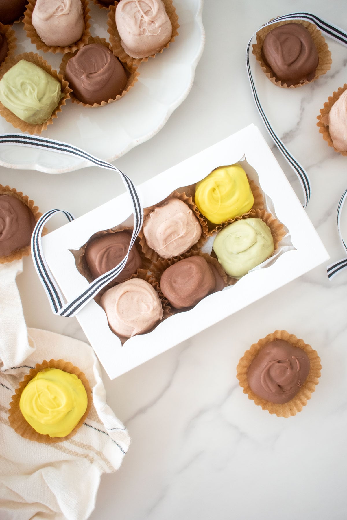 mint meltaways in a candy box on white marble counter.