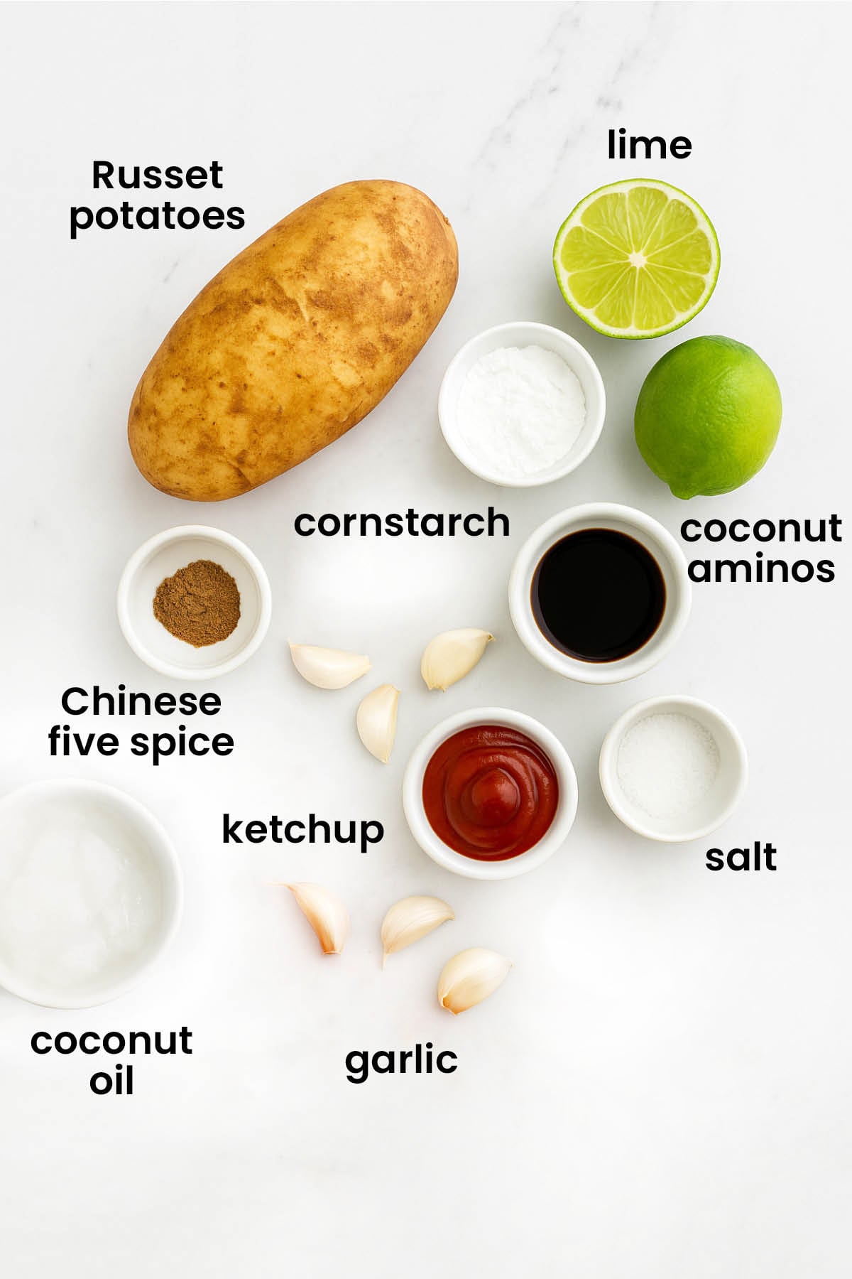 individual ingredients for Chinese five spice garlic French fries laid out against a white background.