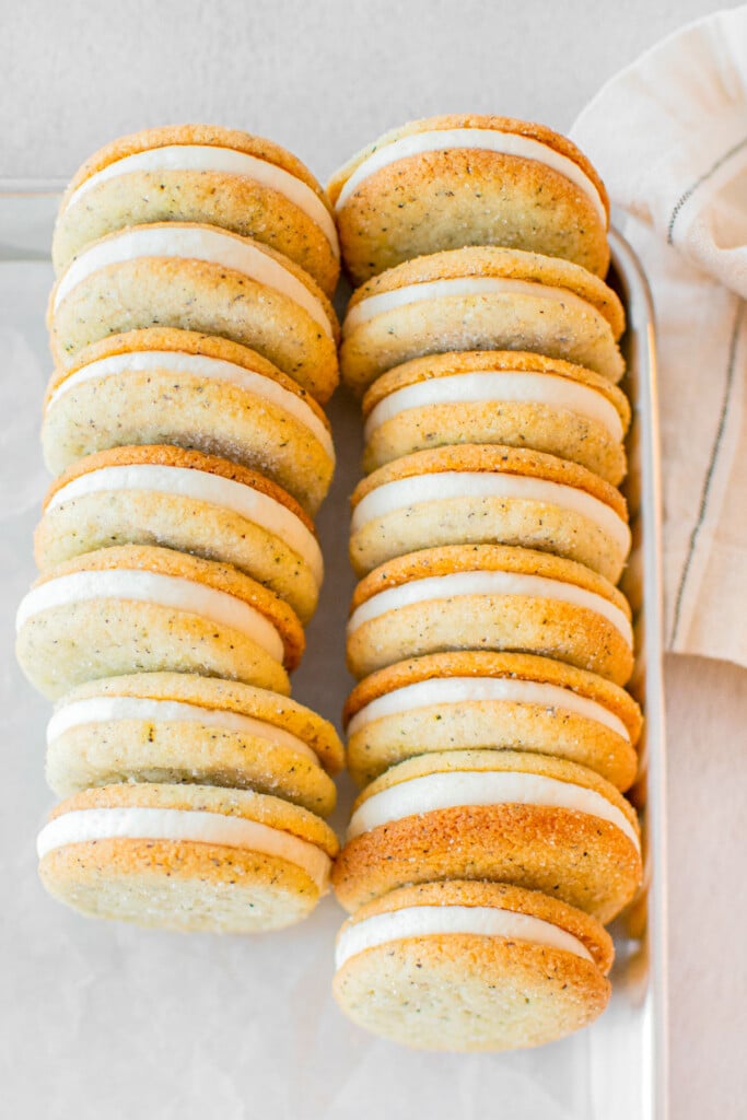 baking sheet of earl grey sandwich cookies on a grey counter.