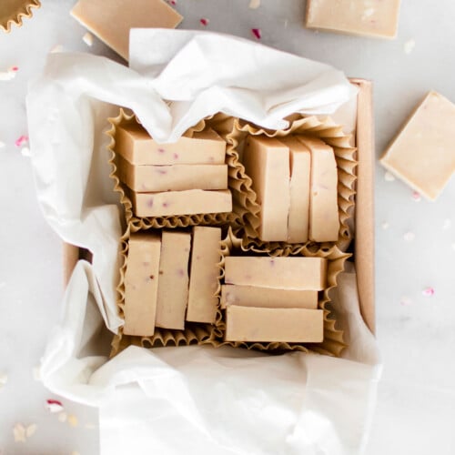 pink peppermint ice in a brown candy box on a white marble counter.