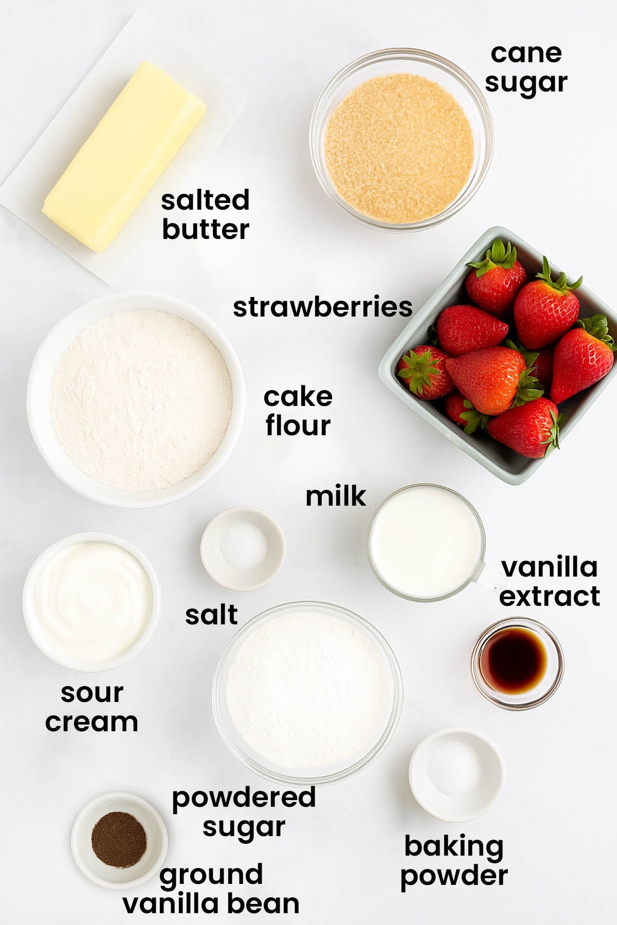 individual ingredients for eggless strawberry shortcake laid out against a white background.