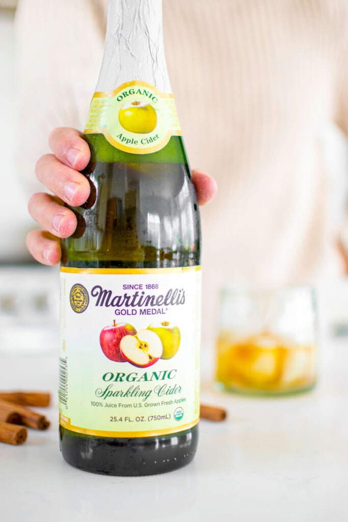 organic sparkling apple cider bottle on kitchen counter.