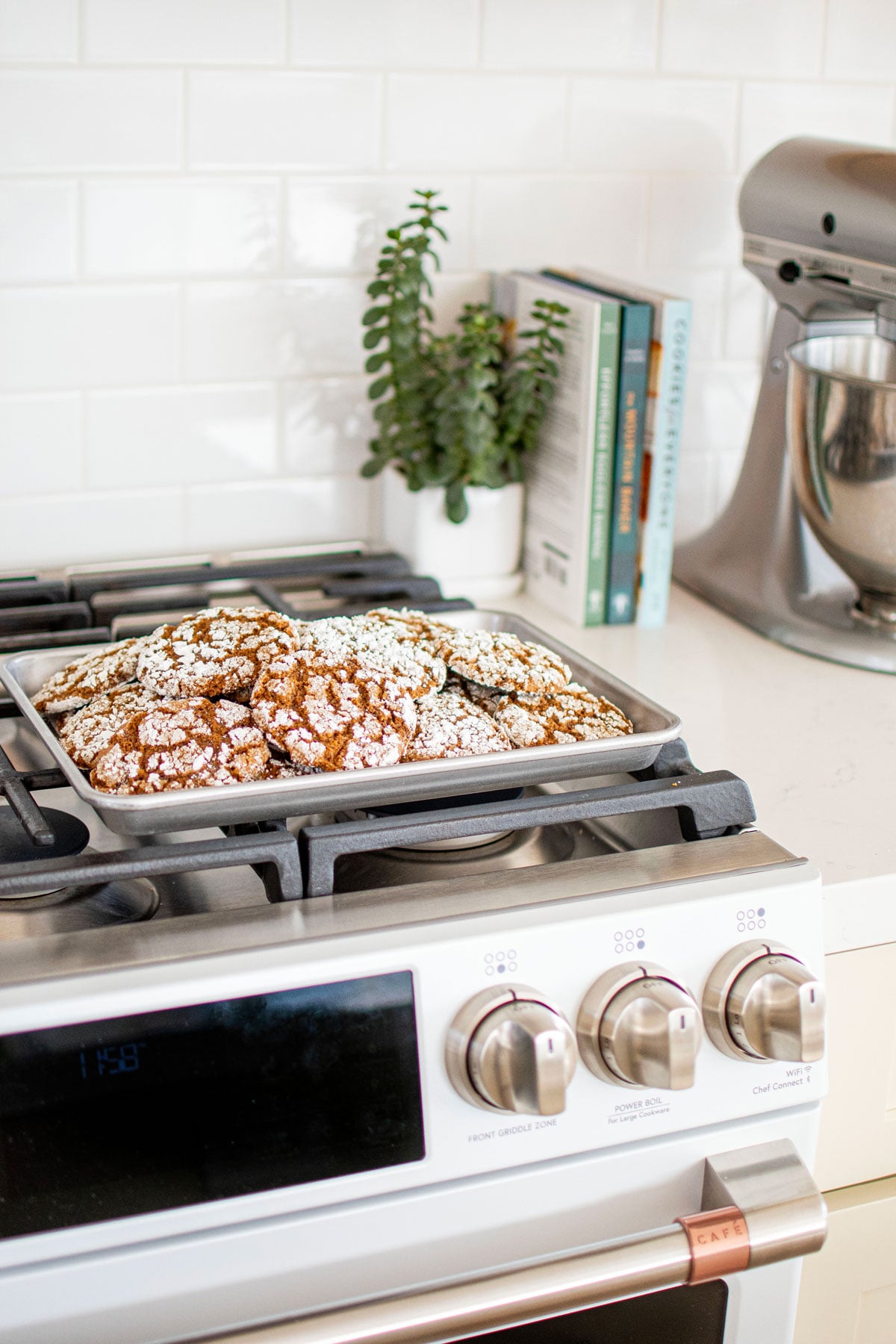 gingerbread crinkle cookies on a baking sheet on a an oven.