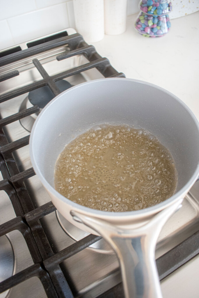 simple syrup in a small pot on a stovetop.