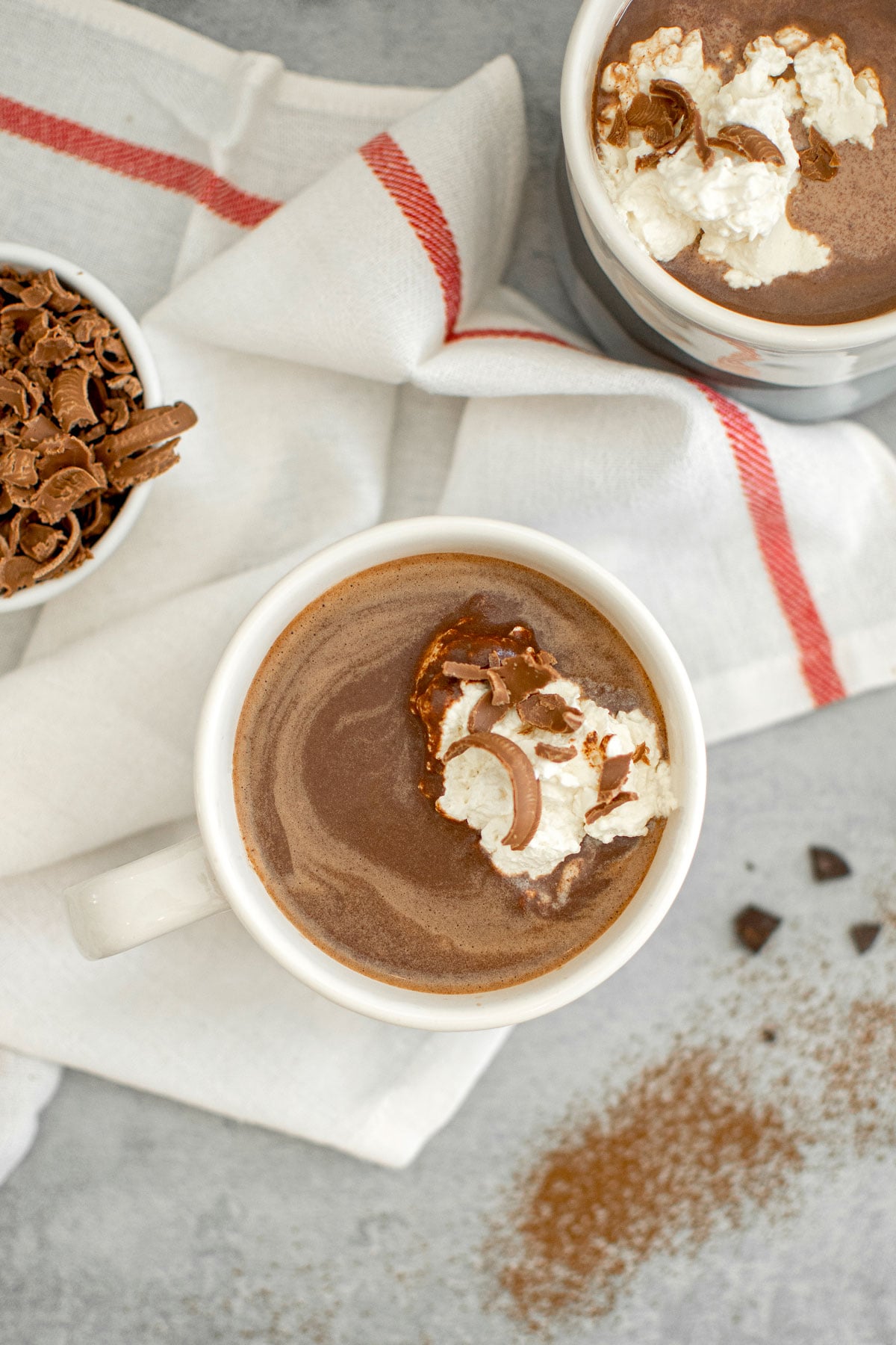 dark hot chocolate with homemade whipped cream and milk chocolate shavings on top.