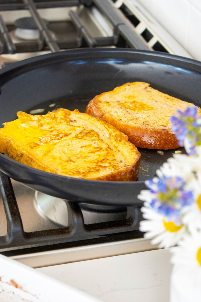 cooked meyer lemon french toast in a black skillet on the stovetop.