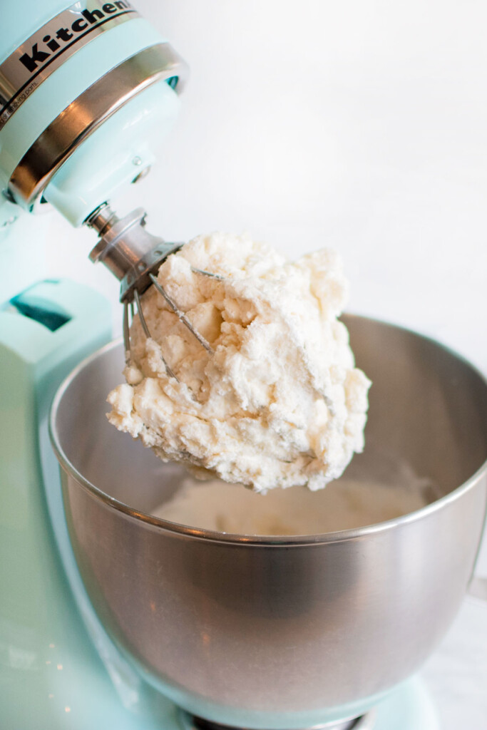 chocolate malt french macaron batter partially mixed in a stand mixing bowl.