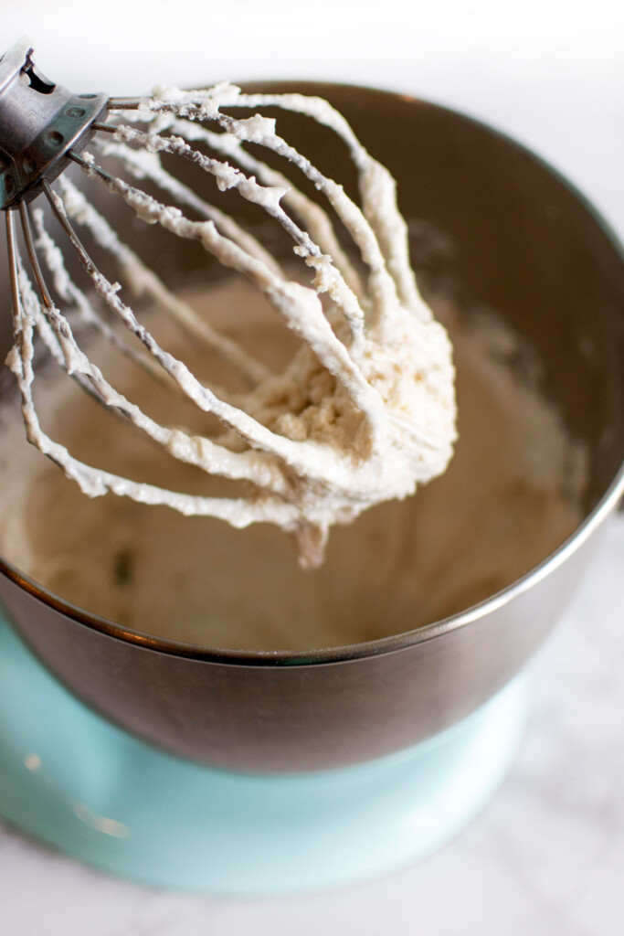 chocolate malt french macaron batter partially mixed in a stand mixing bowl.