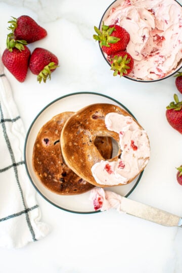 strawberry cream cheese spread on a bagel