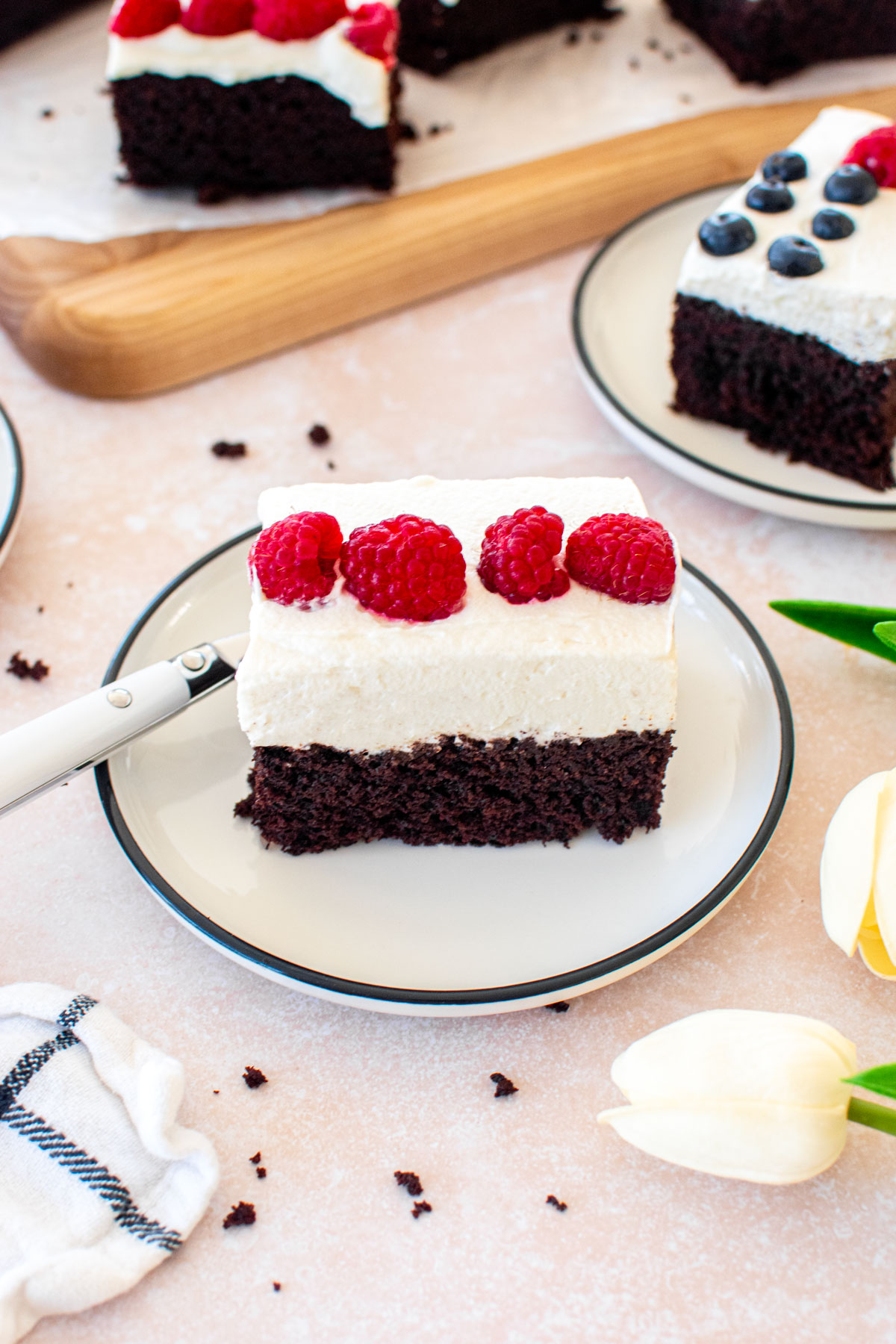 slice of chocolate berry flag cake on a dessert plate on a table.
