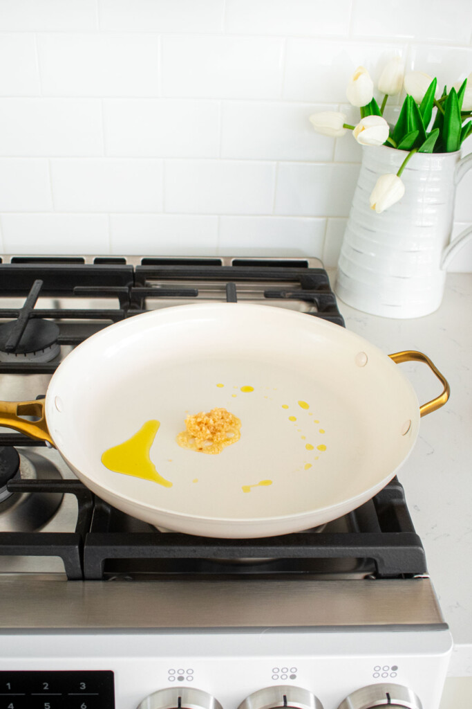 olive oil and garlic in a large skillet on the stovetop.