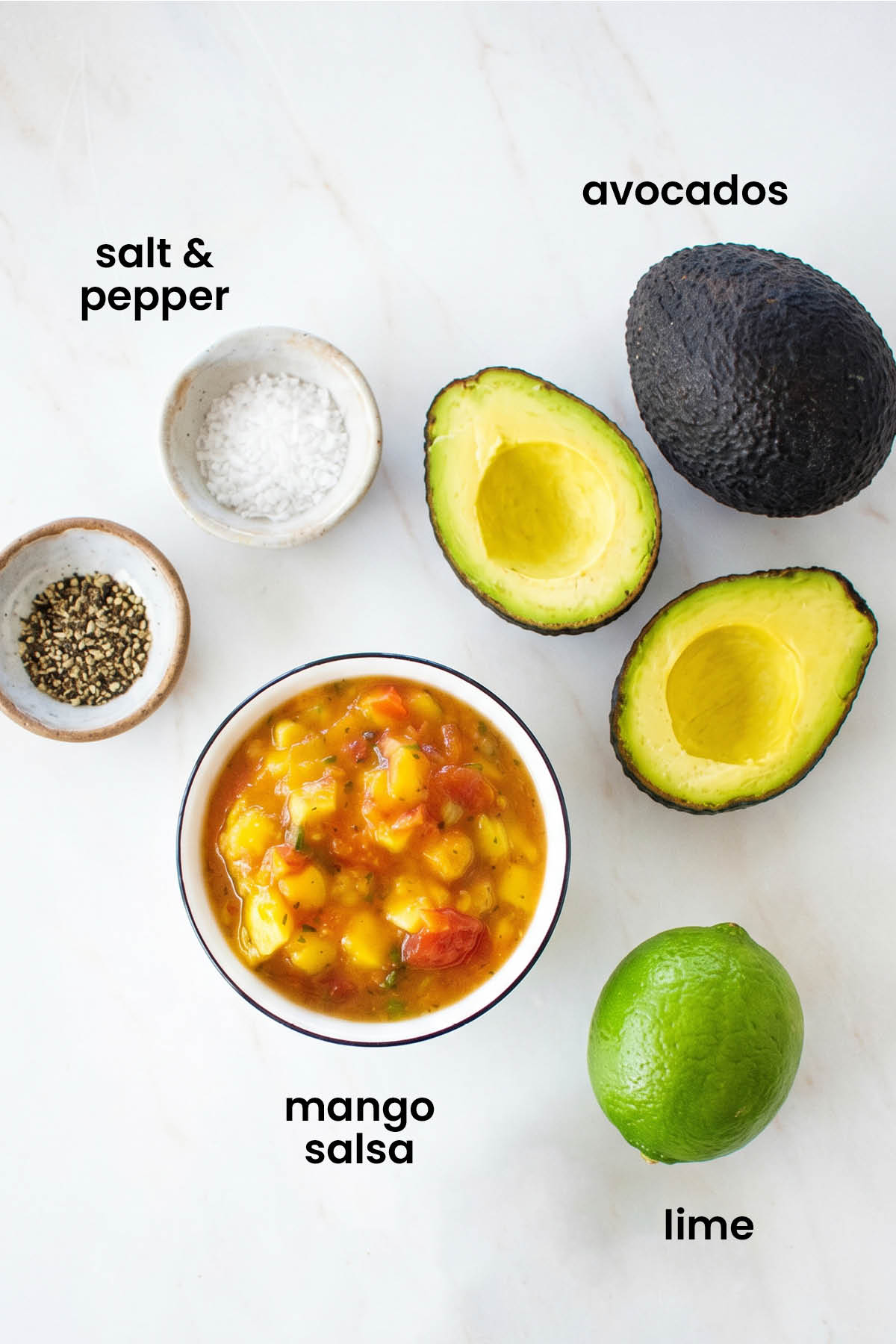 individual ingredients for 3 ingredient homemade mango guacamole laid out against a white background.