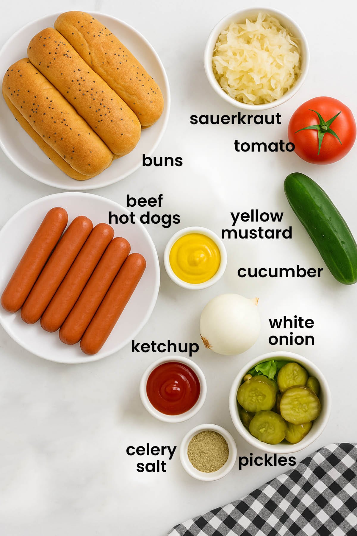 individual ingredients for organic chicago style hot dogs with sauerkraut laid out against a white background.