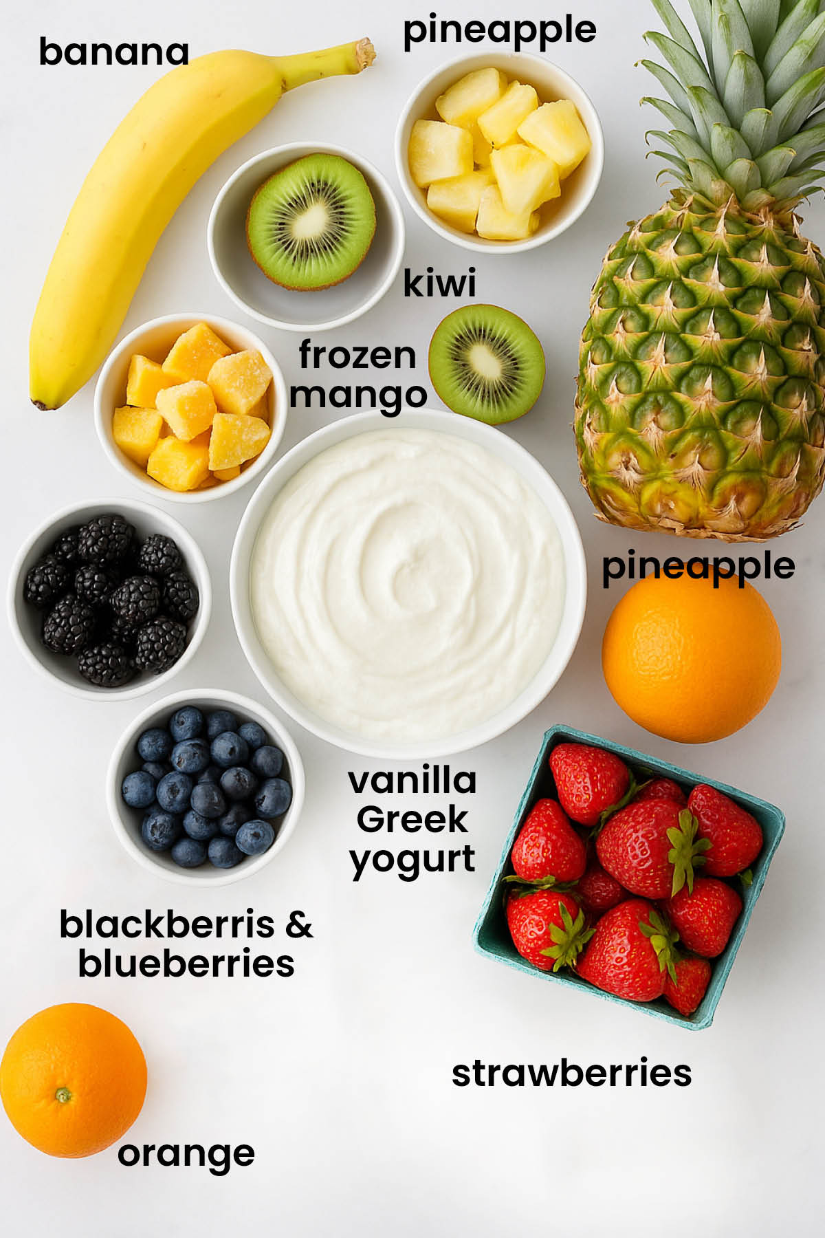 individual ingredients for rainbow smoothie bowl with greek yogurt laid out against a white background.