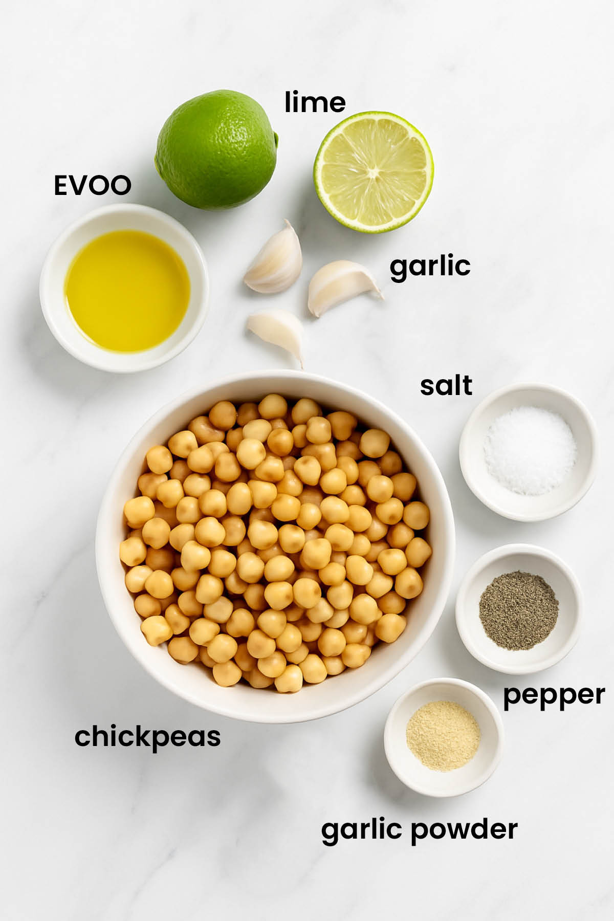 individual ingredients for garlic lime hummus laid out against a white background.