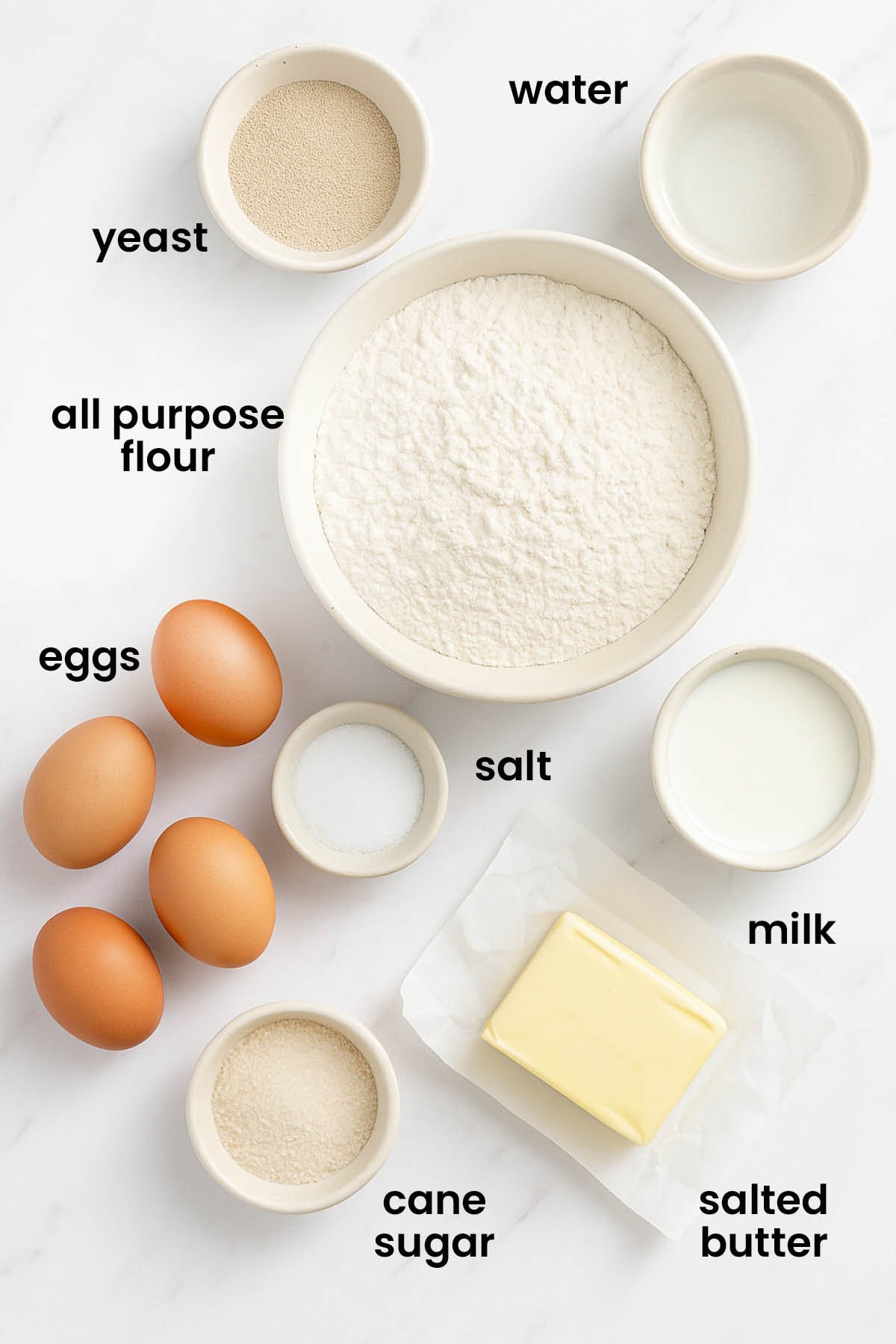 individual ingredients for organic brioche buns with instant yeast laid out against a white background.