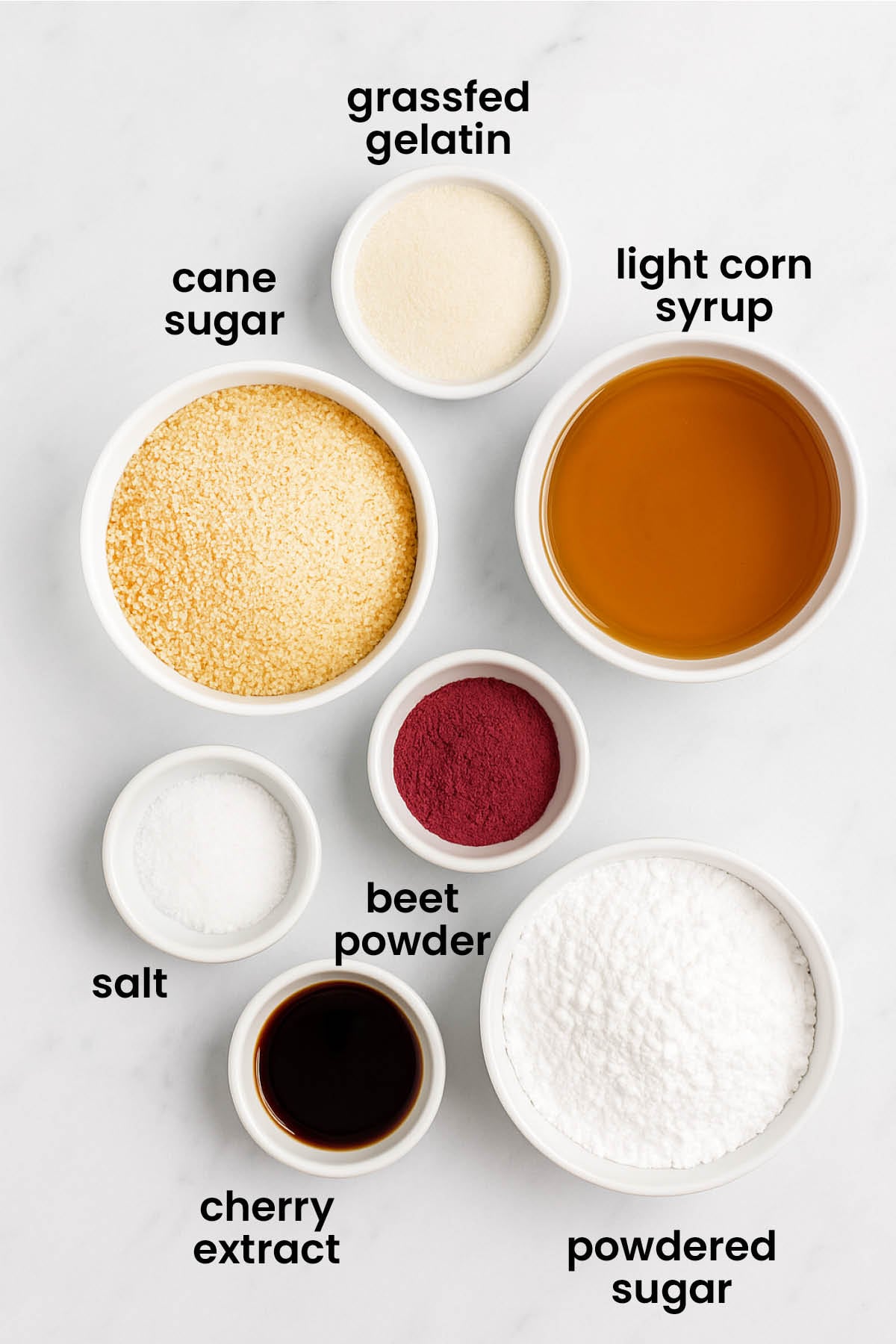 individual ingredients for homemade cherry marshmallows laid out against a white background.
