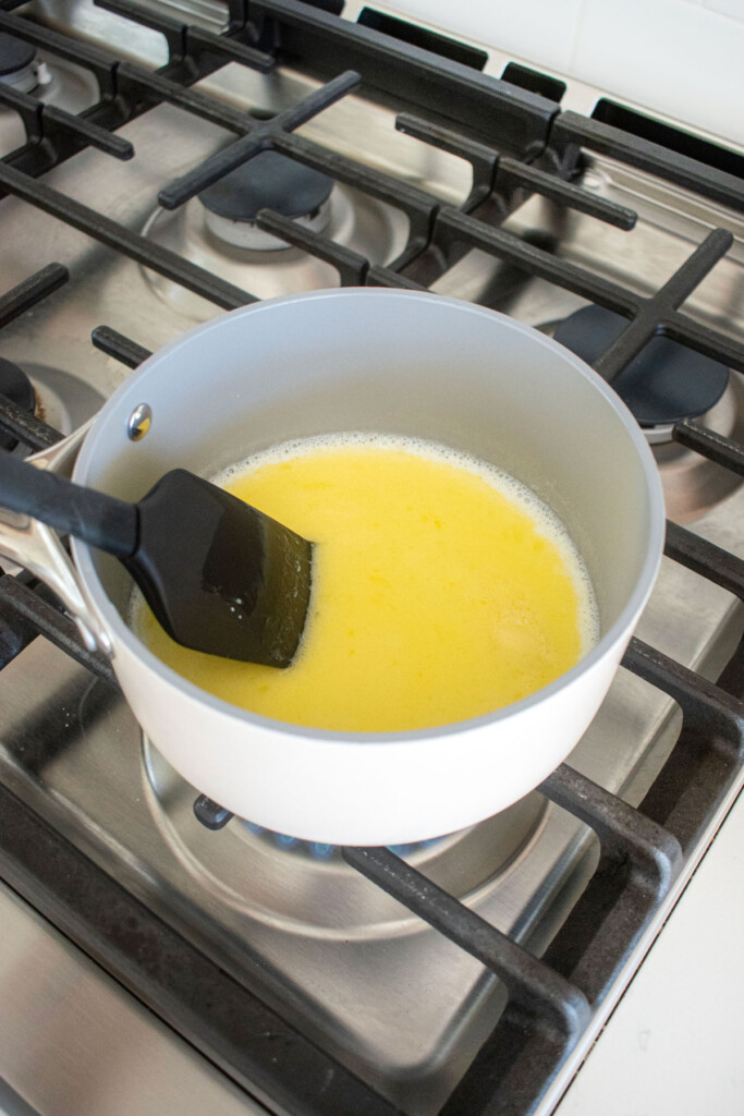 melted butter and milk in a small pot on the stovetop.