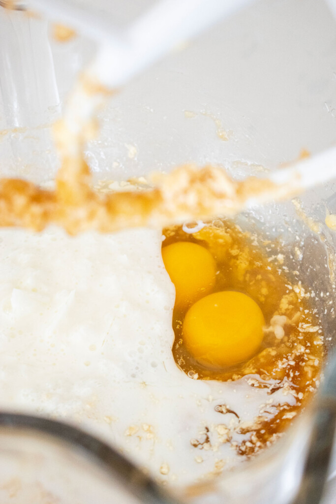 wet ingredients for blueberry buttermilk banana bread in a glass mixing bowl.