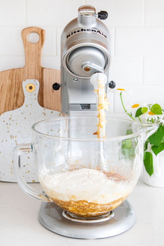 ingredients for blueberry buttermilk banana bread in a glass stand mixing bowl.