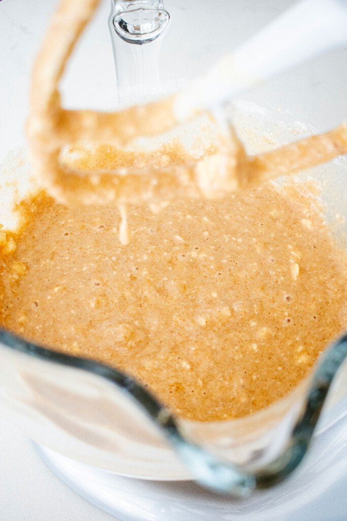 banana bread batter in a glass mixing bowl.