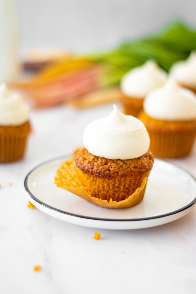 unwrapped brown sugar carrot cupcake on a plate.