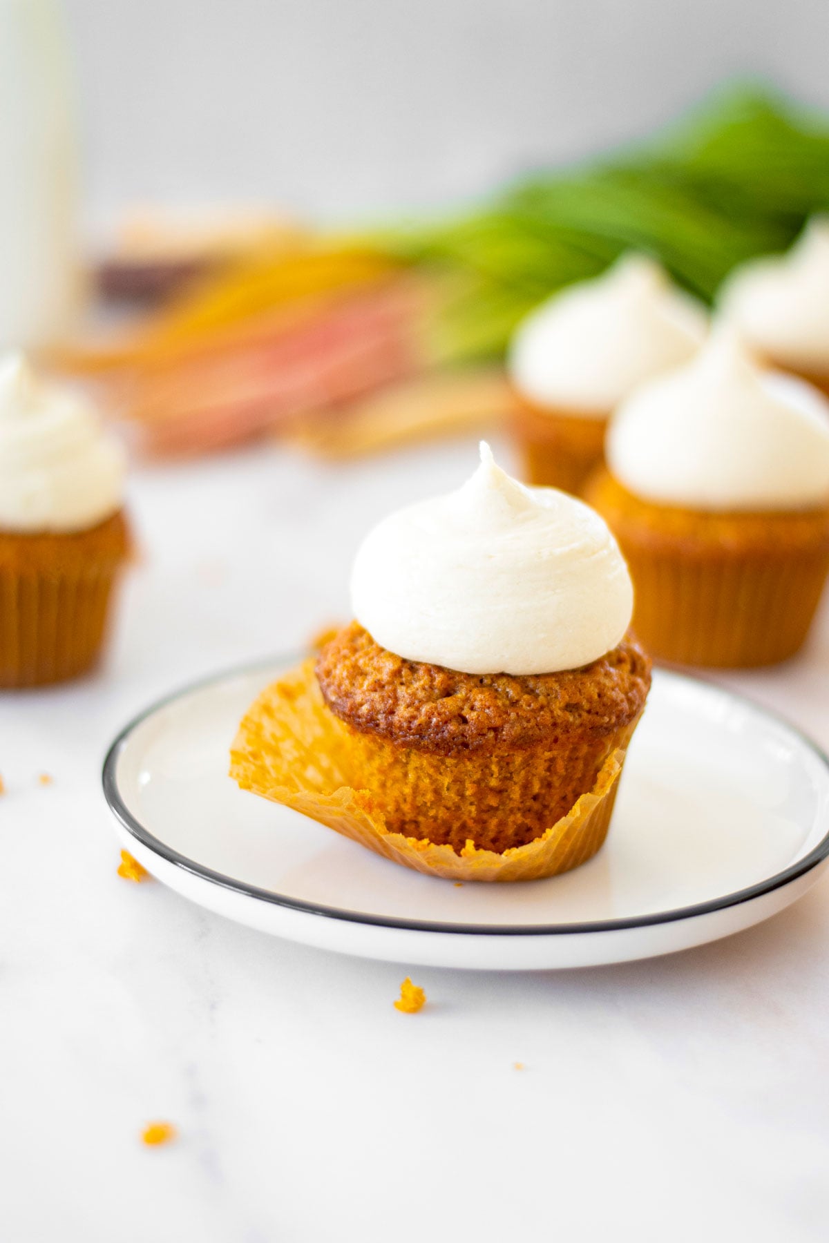 unwrapped brown sugar carrot cupcake on a plate.