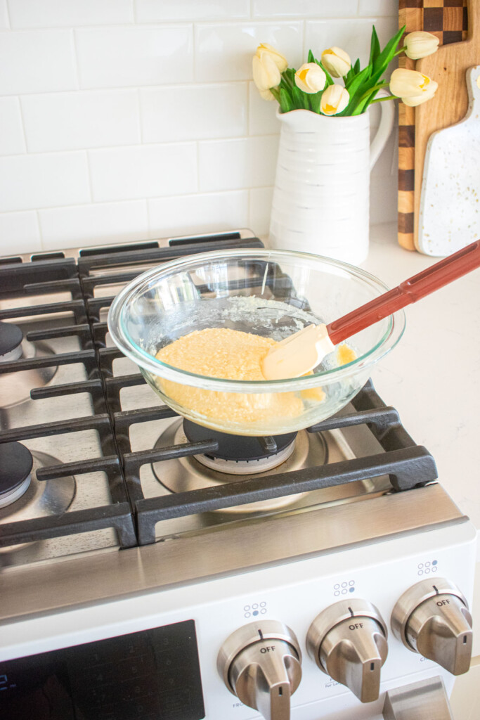 florentine cookie dough in a glass mixing bowl with a spatula resting on top of a stovetop.