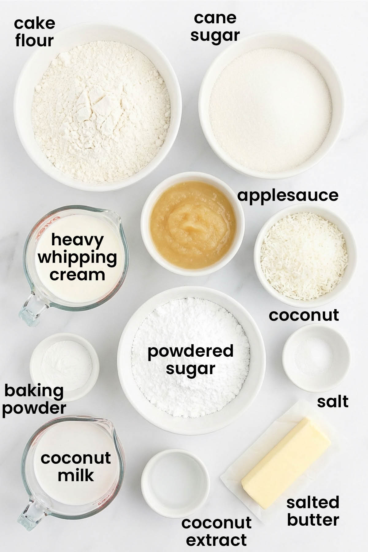 individual ingredients for eggless coconut sheet cake laid out against a white background.