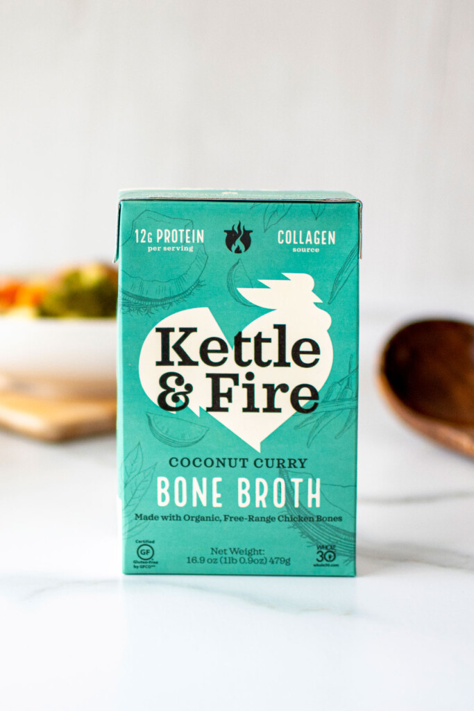 coconut curry bone broth container on a white marble countertop.