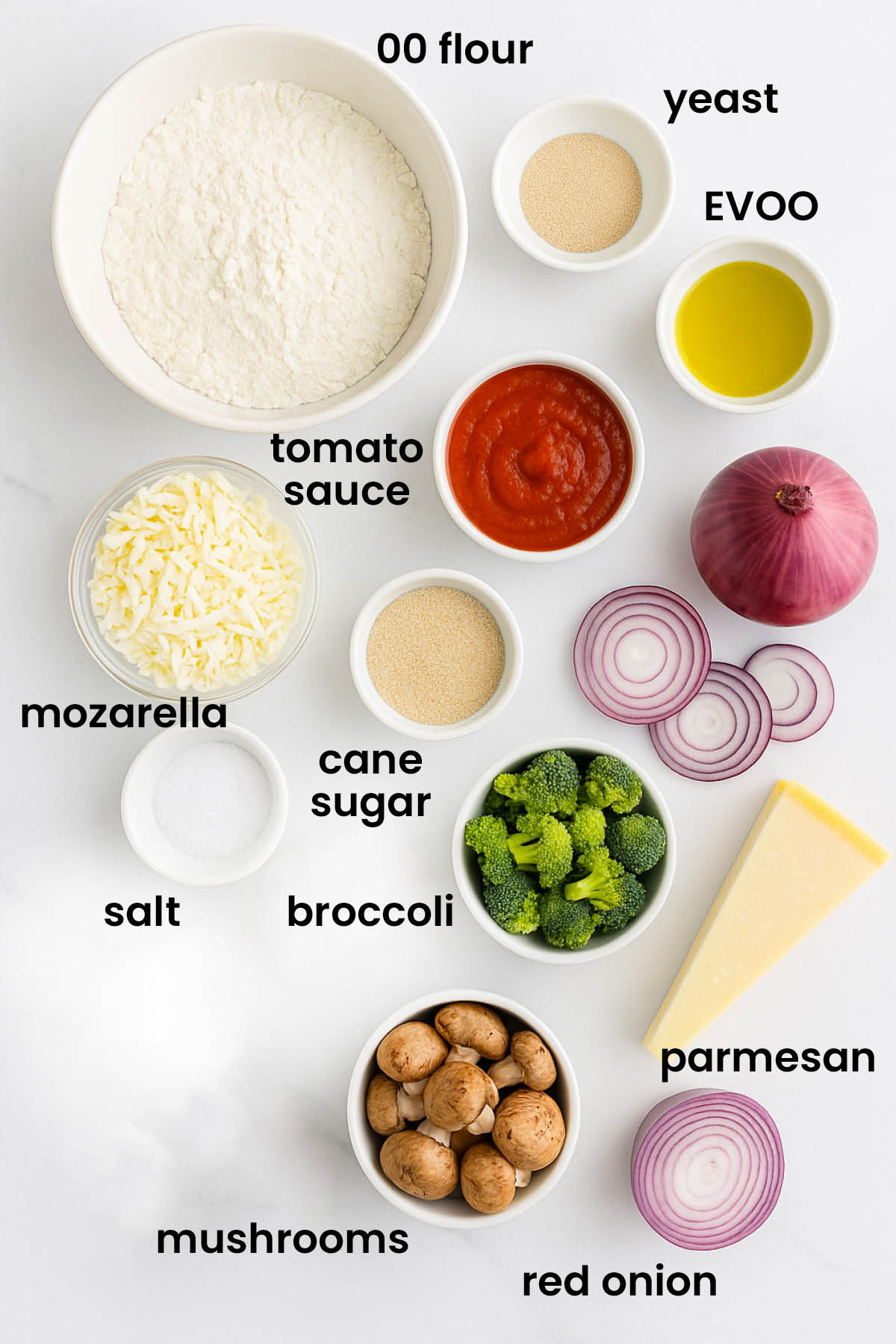 individual ingredients for mushroom broccoli pizza with homemade crust laid out against a white background.