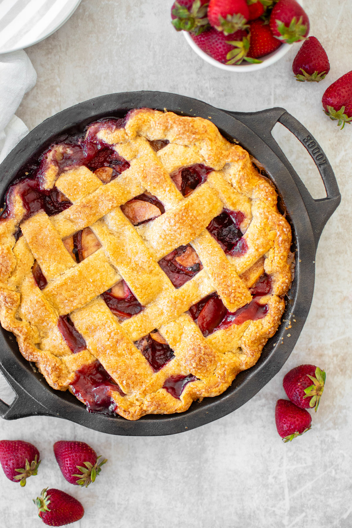 apple berry pie in a cast iron pie pan.