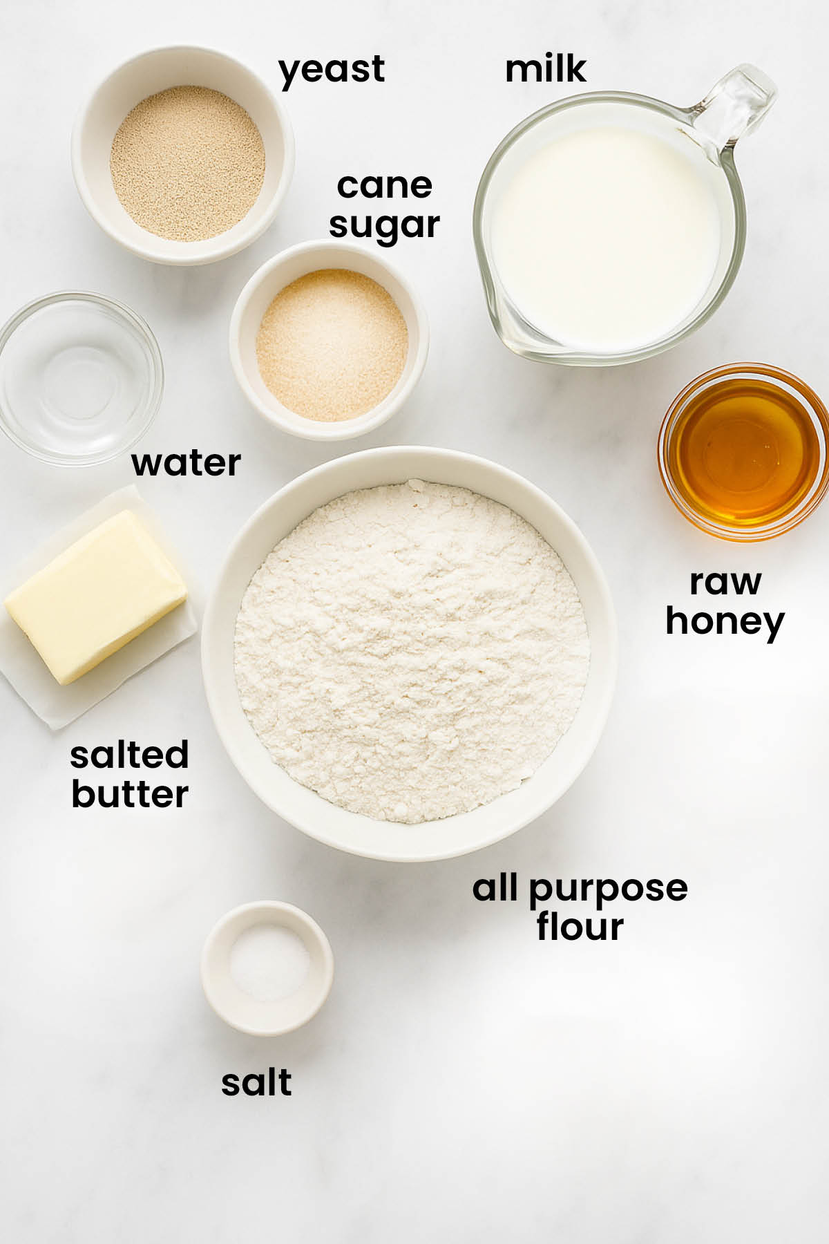 individual ingredients for honey butter dinner rolls laid out against a white background.