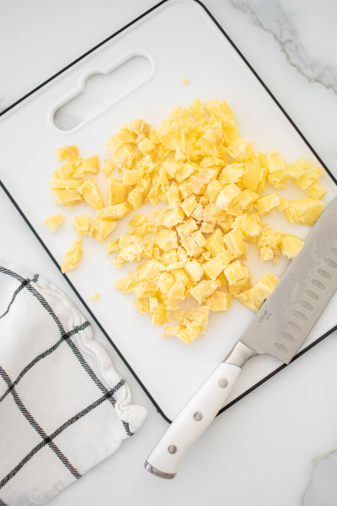 butter cut into small cubes on a cutting board on the counter.