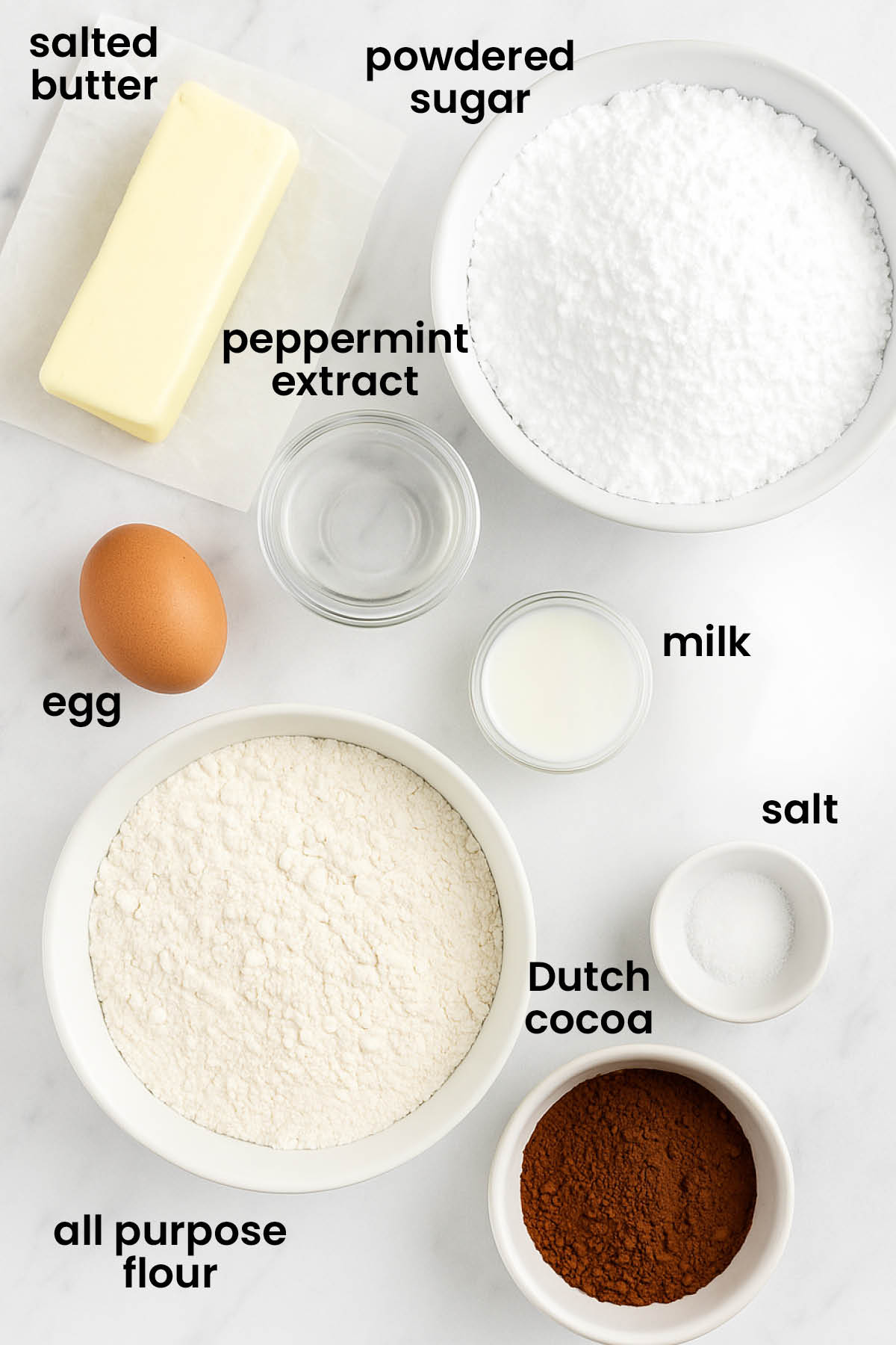 individual ingredients for chocolate peppermint Kourambiethes (Greek Butter Cookies) laid out against a white background.