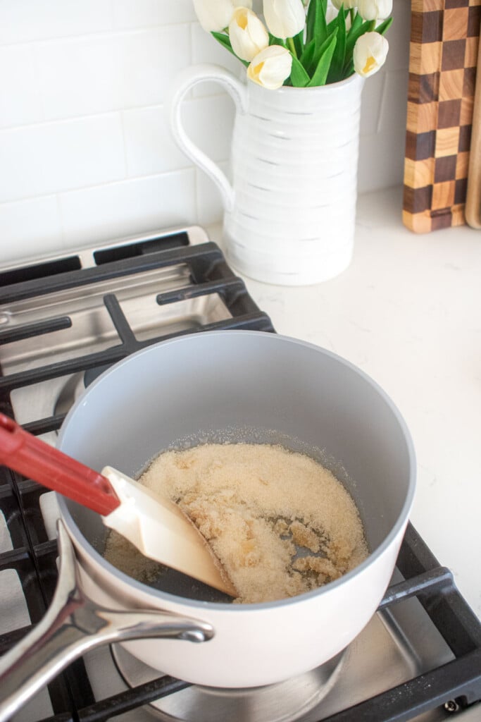 cane sugar in a pot, caramel being made in a pot on the stovetop.