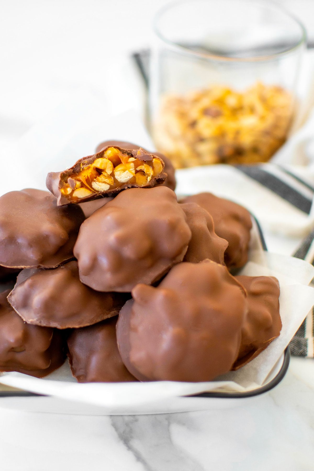 platter of peanut turtle candy on a marble countertop.