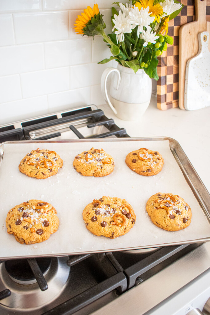 peppermint pretzel chocolate chip cookies on a baking sheet on an oven.