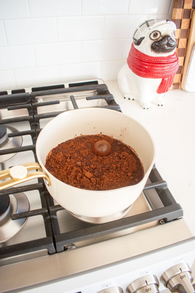 ingredients for homemade chocolate marshmallows in a small pot on the stovetop.