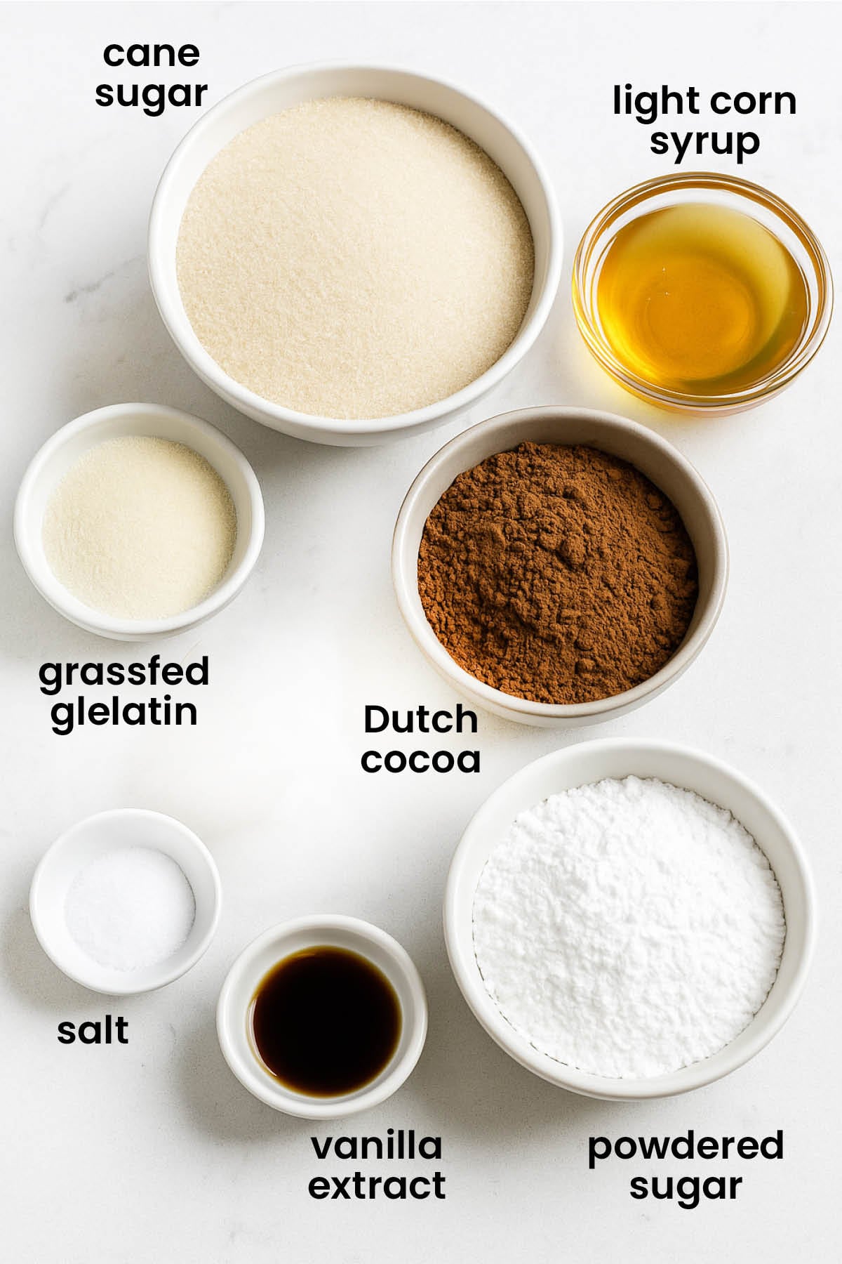 individual ingredients for homemade chocolate marshmallows laid out against a white background.