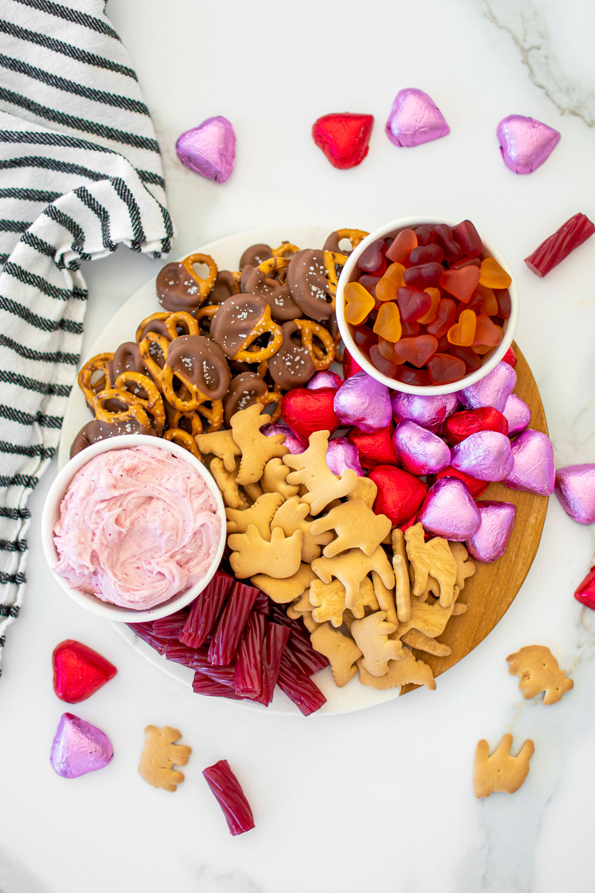 valentine's day charcuterie board on a white marble table.