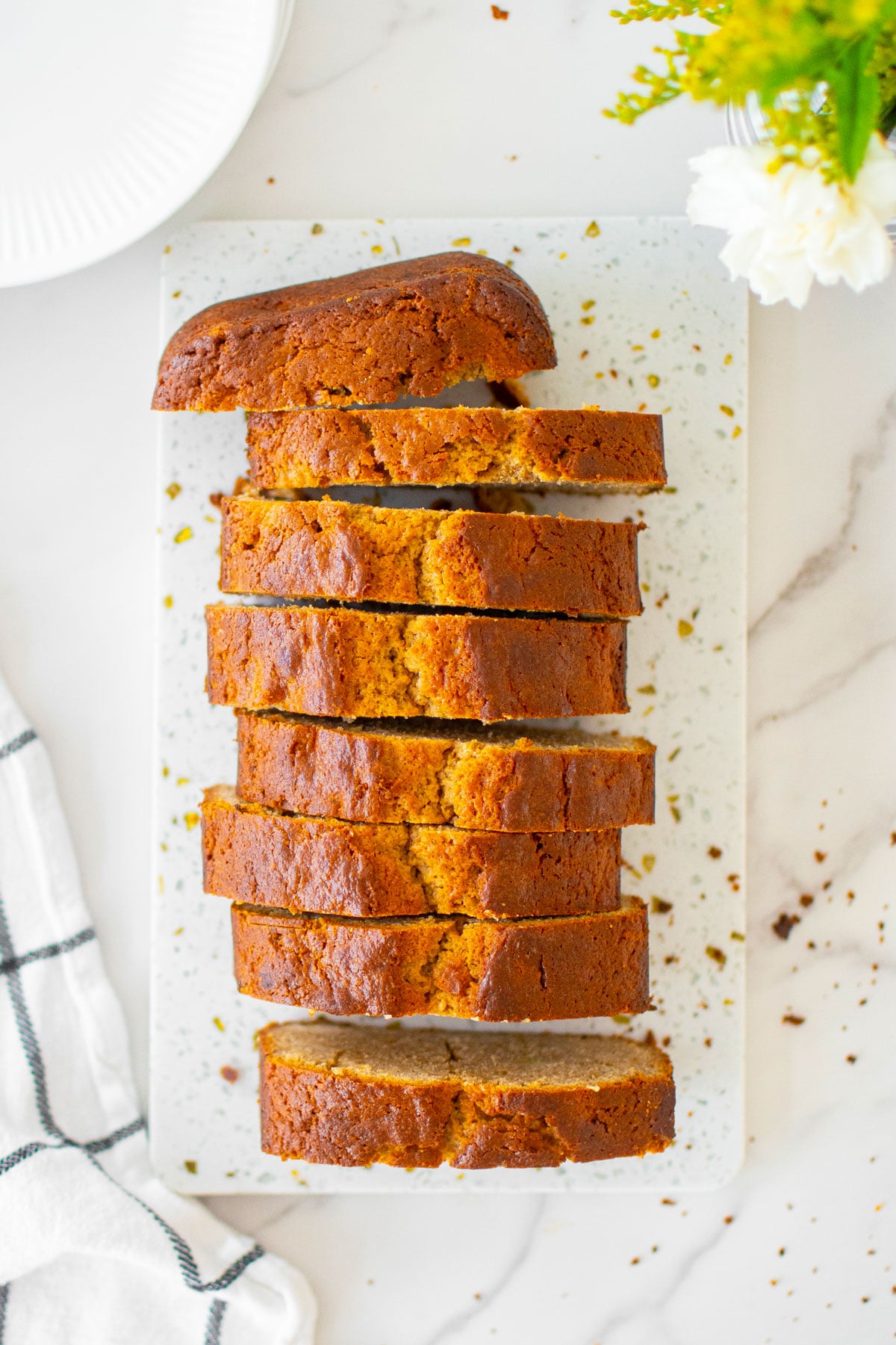almond butter banana bread slices on a white marble board.