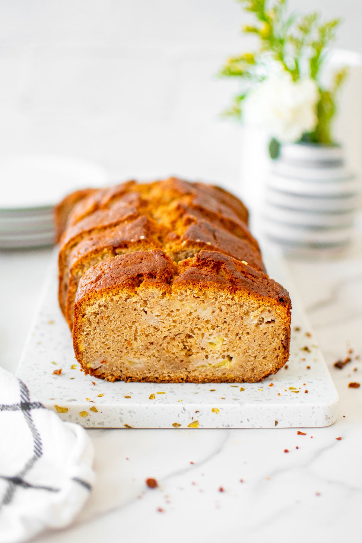 almond butter banana bread slices on a white marble board.