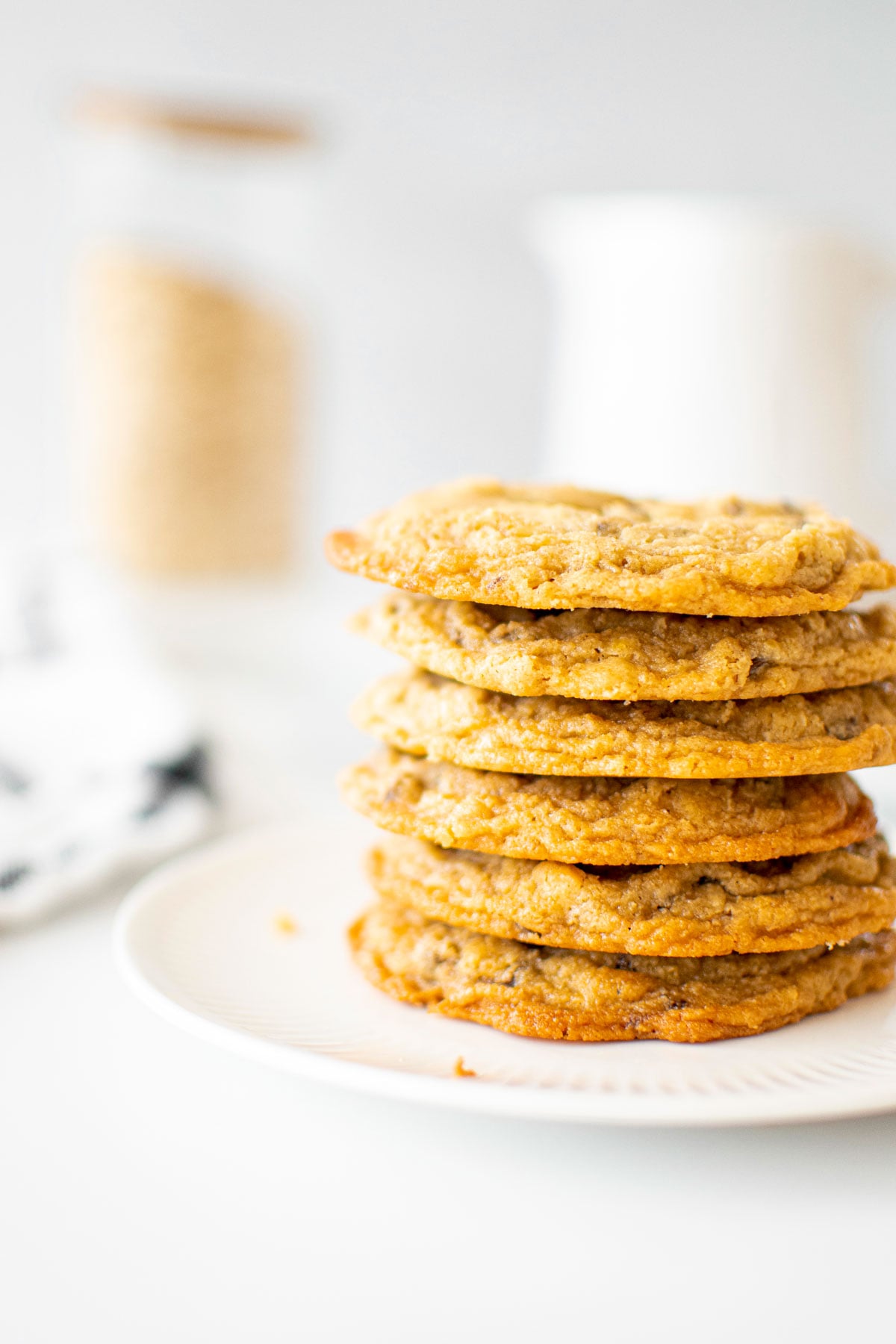 stack of oatmeal cashew butter chocolate chip cookies on a plate on a marble counter.