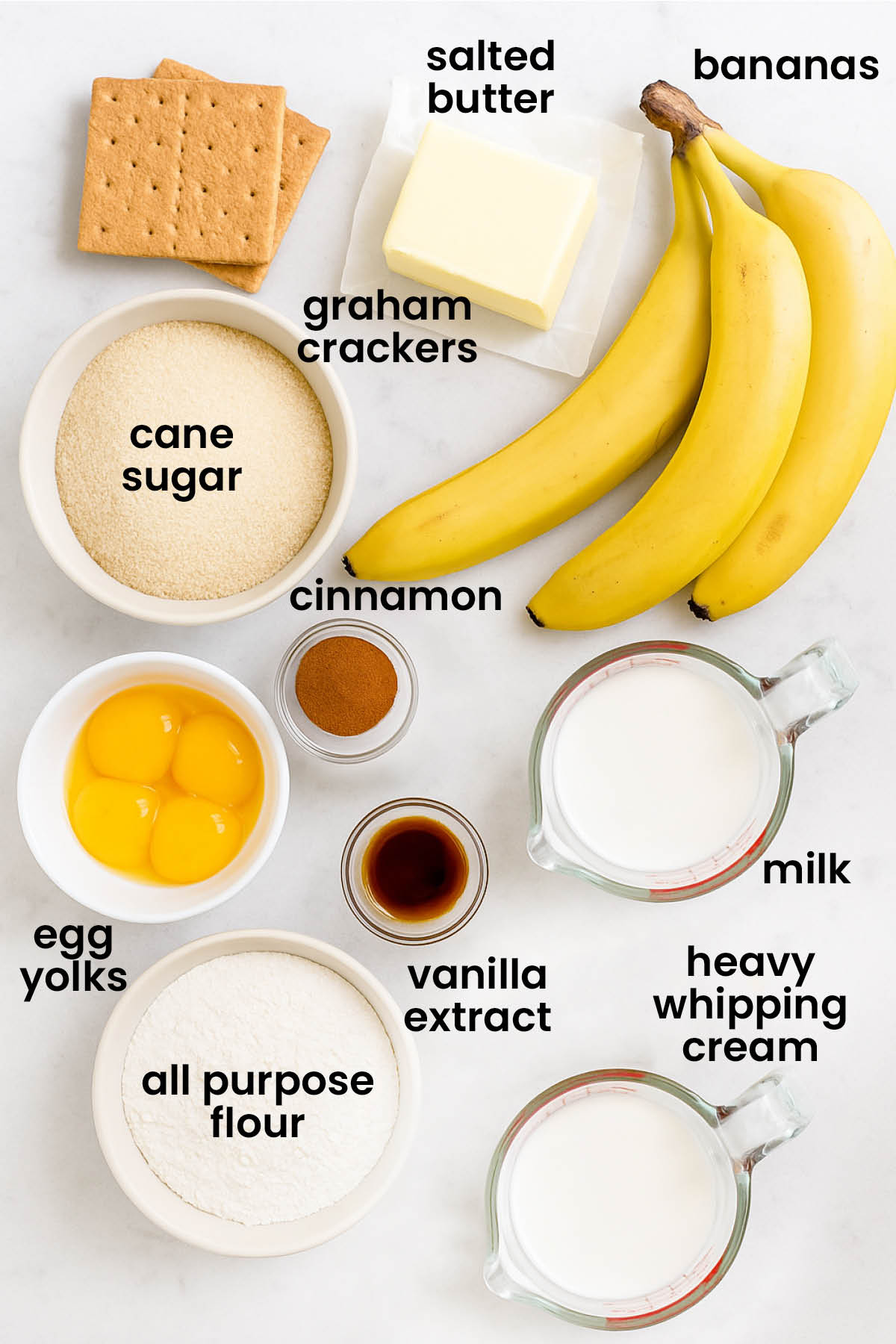 individual ingredients for banana cream pie with graham cracker crust laid out against a white background.